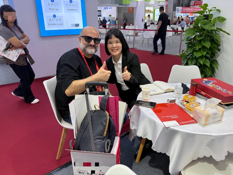 Rongda team communicates with packaging industry customer during All in Print China exhibition